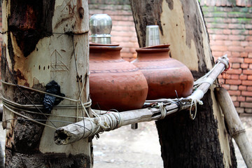 Mud pot filled with fresh drinking water outdoor in nature during summer season.