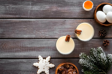 Make festive drink eggnog - ingredients on dark wooden background top view frame copy space