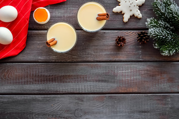 Make festive drink eggnog - ingredients on dark wooden background top view frame copy space
