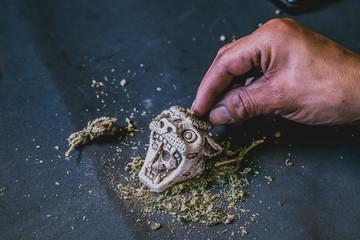 latin man wrapping marijuana joint top view pov