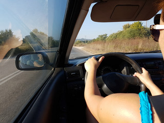 Fototapeta premium driving steering wheel road wooman's hands