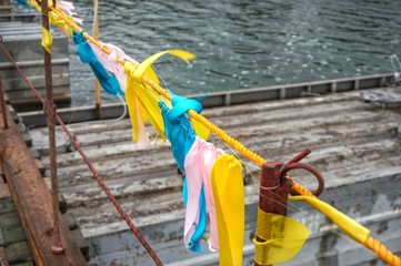 Colorful ribbons on the fence fluttering in the wind.