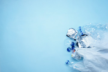 plastic trash and bottles with a blue background