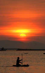 Naklejka na ściany i meble silhouette of boater at sunset