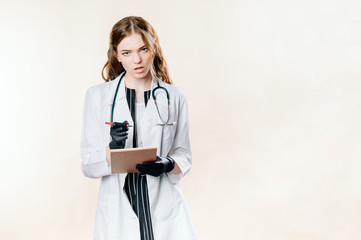 Girl doctor blond young light background studio day beautiful one positive tablet looking smiling concept of remote customer care online patients.