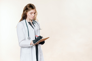 Girl doctor blond young light background studio day beautiful one positive tablet looking smiling concept of remote customer care online patients.