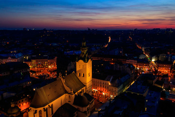 Aerial night view of illuminated Latin cathedral and Rynok square in Lviv, Ukraine. View from Lviv town hall