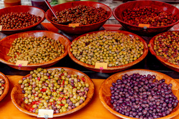 Pickled olive .assortment .and other vegetables on farmers market stall.