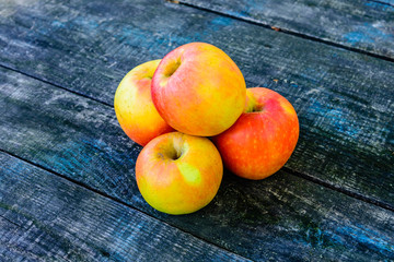 Pile of the ripe apples on wooden table