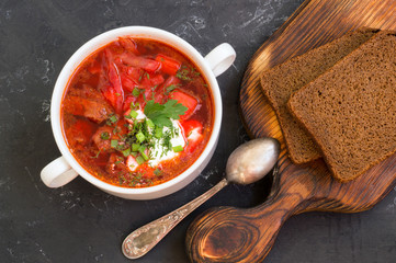 traditional Ukrainian Russian soup (borscht) from beet with greens and sour cream.