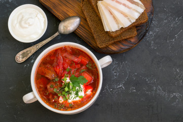 traditional Ukrainian Russian soup (borscht) from beet with greens and sour cream.