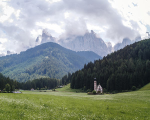 Fototapeta na wymiar Landscapes with San Giovanni Church and small village in Val di Funes, Dolomite Alps, South Tyrol, Italy, Europe