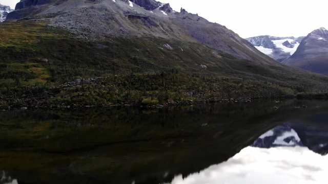 Beautiful panning shot of the amazing green innerdalen on a cold and cloudy summerday in norway
