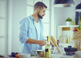 Smiling and confident chef standing in large kitchen