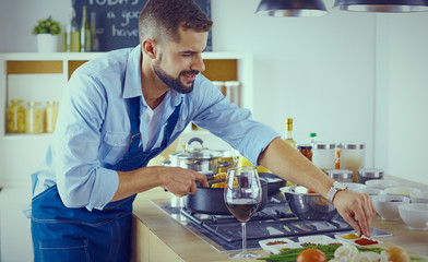 Smiling and confident chef standing in large kitchen