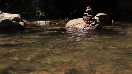 Rock stack or cairns at Veal Puoch Waterfalls in the mountains of Kampong Trach in Kampot Cambodia showing concept of harmony, balance and mindfulness