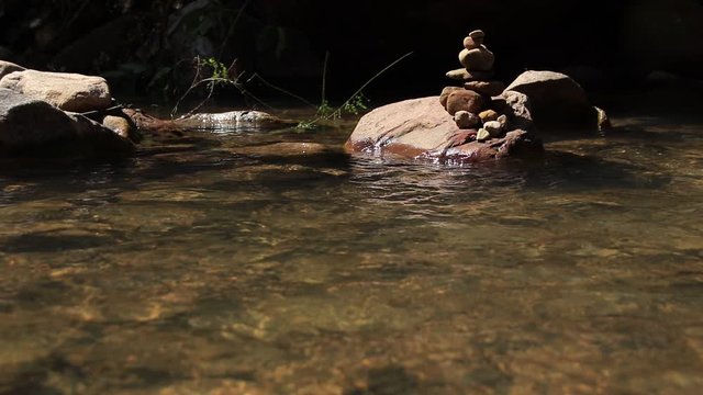 Rock stack or cairns at Veal Puoch Waterfalls in the mountains of Kampong Trach in Kampot Cambodia showing concept of harmony, balance and mindfulness