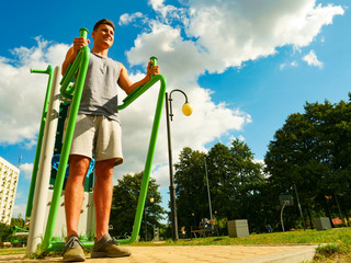 Man doing exercises in outdoor gym
