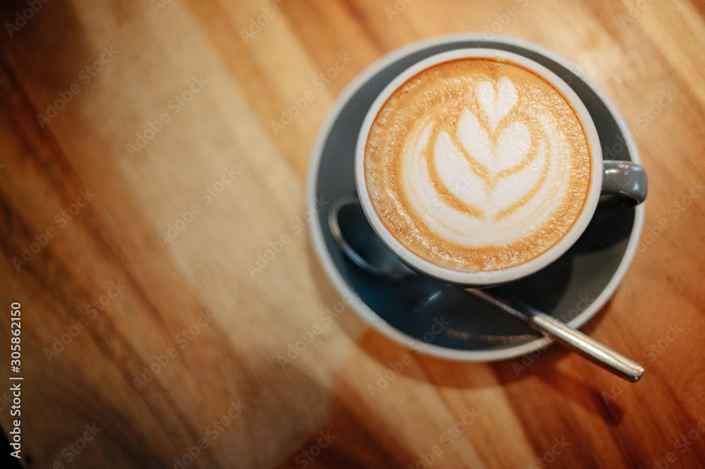 Wall mural hot latte coffee placed on a wooden table