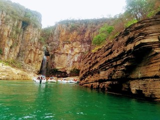  cliff with  green waters