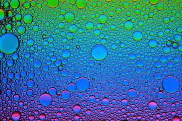 Background of colorful oil drops in water surface - abstraction