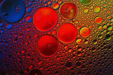Background of colorful oil drops in water surface - abstraction
