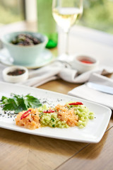 Salmon tartare with cucumber and sesame seeds. Tasting dish on a wooden table.