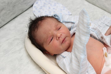 A small newborn boy 7 days in the hospital is going home to his parents. Hair dark skin dark. © Alarina_Art