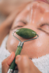 Guasha Jade Stone Roller Face Treatment in a Beauty Center