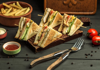 four small chicken club sandwich portions on bamboo skewers