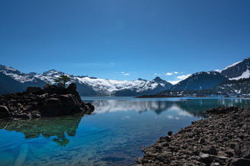 turquoise coloured lake and snow mountains  in Garibaldi provincial park, BC, Canada