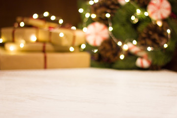 Gift boxes and Christmas wreath with a luminous garland. Blurred background without focus with bokeh