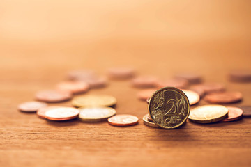 20 cent euro coins on wooden table, image for money concept.