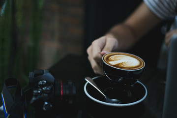 holding a cup of coffee