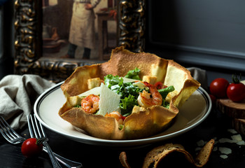 shrimp salad with cheese and lettuce in crusty flatbread bowl