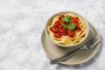 Spaghetti bolognese on grey concrete background