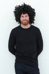 Fototapeta na wymiar bearded man in a wig. isolated on white