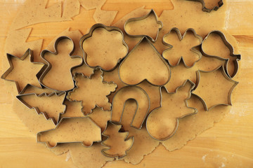 Making Christmas gingerbread to different types as snowman, heart, horse shoe, star and quatrefoil. Christmas coming soon together with Baby Jesus or Santa Claus. Concept of winter holidays