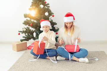 Single parent and holidays concept - Portrait of mother and son celebrating christmas at home on christmas eve