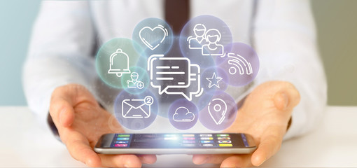 Obraz premium Businessman holding a cloud of social media network icon