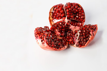 Juicy and ripe pomegranate isolated on white background.