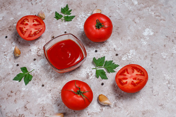 Homemade ketchup sauce and ingredients on brown concrete background. Top view