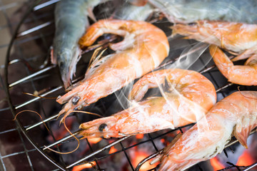 Grilled shrimps on the stove flaming grill on party camping