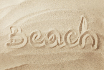 Fototapeta na wymiar Summer message on the beach sand
