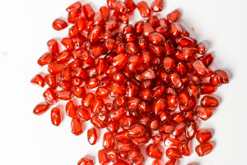 Pomegranate fruit seeds isolated on white macro background