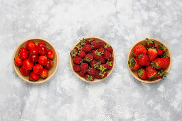 Fresh organic berries on grey concrete background,top view,copy space