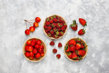 Fresh organic berries on grey concrete background,top view,copy space