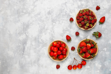 Fresh organic berries on grey concrete background,top view,copy space