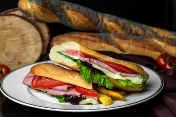 salami sandwich with tomato, cheese and lettuce