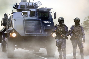 Police special force on standby infront of the armored vehicles during special opps